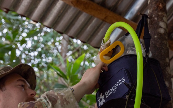 U.S. Army Sgt. Matthew Shelton handles a mosquito trap