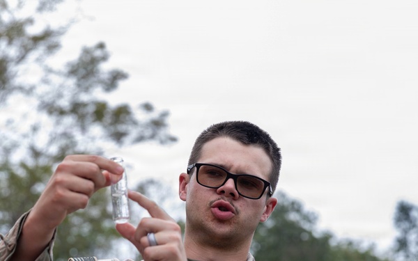 U.S. Army Spc. Craig Lee collects water from a handwashing station