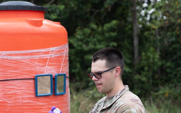 U.S. Army Spc. Craig Lee prepares to seal a water sample