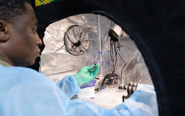 U.S. Army Maj. Timothy Egbo works on vials with mosquito DNA