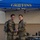 12th Combat Aviation Brigade hosts Danish Flyver March Two military personnel in U.S. Army OCP (Operational Camouflage Pattern) uniforms are posing together under a blue canopy tent labeled 'GRIFFINS' in gold lettering. One individual is wearing a backpack and they appear to be shaking hands or exchanging an item. The setting appears to be an outdoor military event or ceremony.