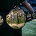 A large decorative championship-style belt is being held by a person on what appears to be an NFL football field. The belt features gold plates with 'Salute to Service' text, '2026 Champion' inscription, and logos from the New York Giants (NY) and New York Jets on the side plates. The setting appears to be MetLife Stadium, home of both New York NFL teams.