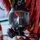 Forged Underwater: PNSY Dive Team Conducts Inspection of New Caisson The image shows a full-face diving mask, branded 'DIVATOR', hanging against a background of red and yellow equipment straps or hoses. The mask features a large rectangular visor, a demand valve/regulator assembly at the bottom, and connected hoses or cables. The equipment appears to be professional-grade commercial or rescue diving gear stored or mounted in a working environment.