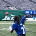 Two players in blue New York Giants uniforms are on the field at MetLife Stadium, with one player throwing a football to another. The scoreboard in the background shows the Giants with 3 points in the 4th quarter, 46:36 remaining, on a 3rd and 7 situation with the ball on the 42. The stadium seats are empty, suggesting this is a pre-game warmup or practice session.