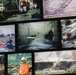 A large display wall featuring multiple archival photographs documenting the September 11, 2001 attacks and their aftermath, including scenes from the Pentagon and World Trade Center sites. The photos show emergency responders, rescue operations, structural damage, and debris removal efforts. A museum visitor or worker in an orange shirt and white hard hat with a respirator mask is visible in the foreground, suggesting this is a memorial or museum exhibit.