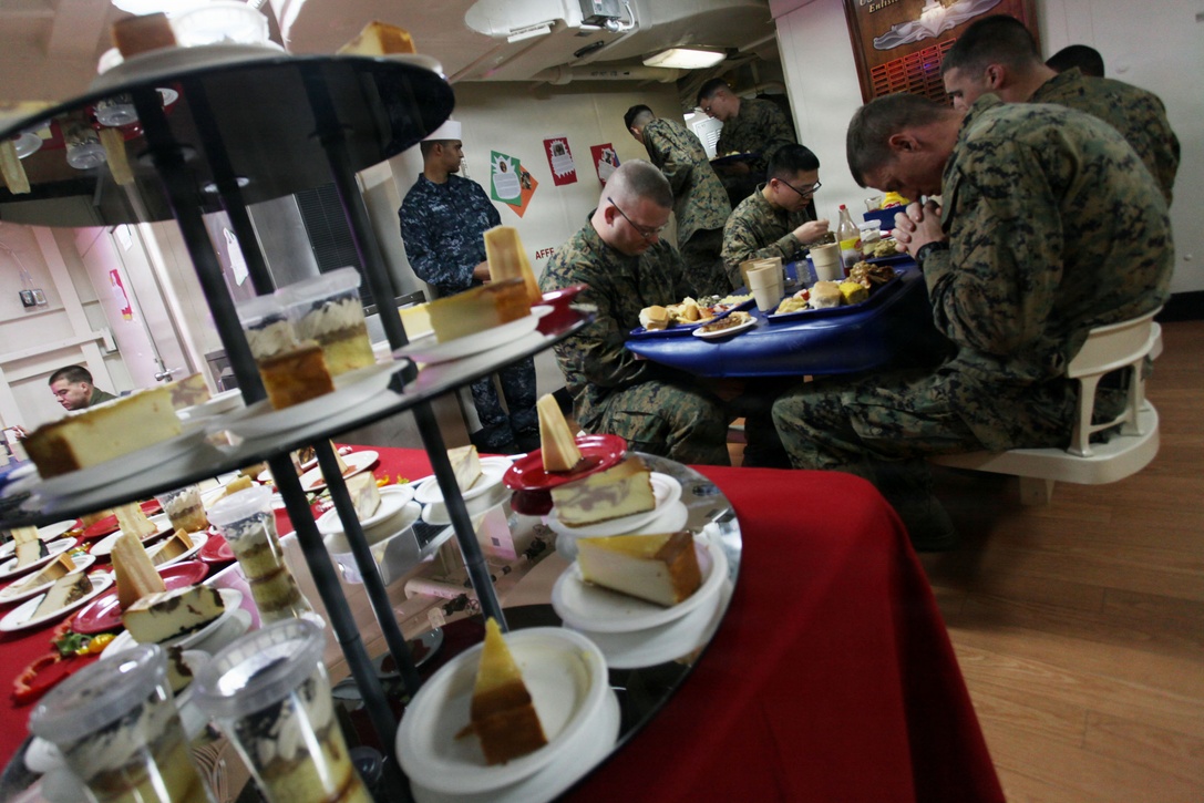 Marines with the 24th Marine Expeditionary Unit say grace before enjoying a Thanksgiving feast aboard the USS New York, Nov. 22, 2012. All three ships of the Iwo Jima Amphibious Ready Group served Thanksgiving dinner to their crew. The 24th Marine Expeditionary Unit is currently deployed as an expeditionary crisis response force in support of maritime security operations and theater security cooperation efforts in the U.S. 6th Fleet area of responsibility. (U.S. Marine Corps photo by Staff Sgt. Robert L. Fisher III)