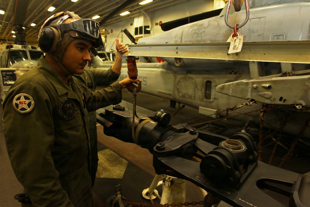 Lance Cpl. Ramon Sapien, a Dallas, native and AH-1W Super Cobra mechanic with Marine Medium Tiltrotor Squadron 261 (Reinforced), 24th Marine Expeditionary Unit, oversees maintenance of a main rotor to an AH-1W Super Cobra aboard USS Iwo Jima, Dec. 3, 2012. The 24th MEU is deployed with the Iwo Jima Amphibious Ready Group and is currently in the 6th Fleet area of responsibility. Since deploying in March, they have supported a variety of missions in the U.S. Central, Africa and European Commands, assisted the Navy in safeguarding sea lanes, and conducted various bilateral and unilateral training events in several countries in the Middle East and Africa. The Cobras, along with UH-1N Hueys, make up the "Skid" detachment for VMM-261 (Rein) and are originally from Marine Light Attack Helicopter Squadron 269, based at Marine Corps Air Station New River, N.C. (U.S. Marine Corps photo by Lance Cpl. Tucker S. Wolf/Released)