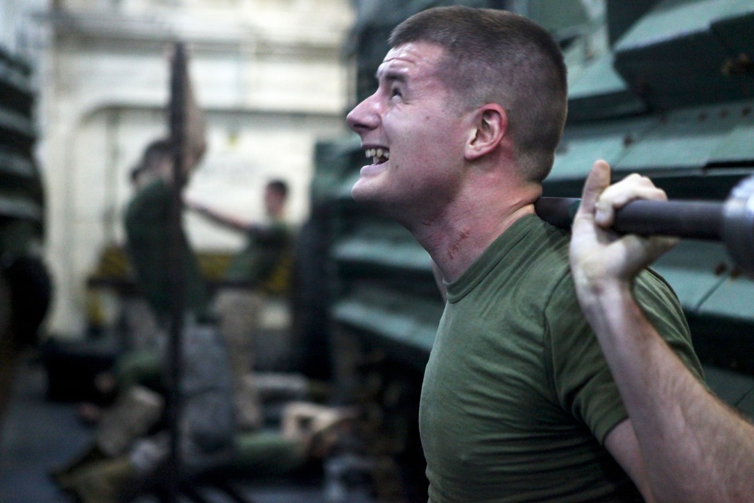 Cpl. Michael Cavahaugh, communications chief with Alpha Company, Battalion Landing Team 1st Battalion, 2nd Marine Regiment, 24th Marine Expeditionary Unit, and Vinemont, Ala., native, performs shoulder presses for combat conditioning during Corporals Course Class 014-13 aboard the USS New York, Dec. 4, 2012. The 24th Marine Expeditionary Unit is deployed with the Iwo Jima Amphibious Ready Group in the 6th Fleet area of responsibility serving as an expeditionary crisis response force capable of a variety of missions from full-scale combat to evacuations and humanitarian assistance.