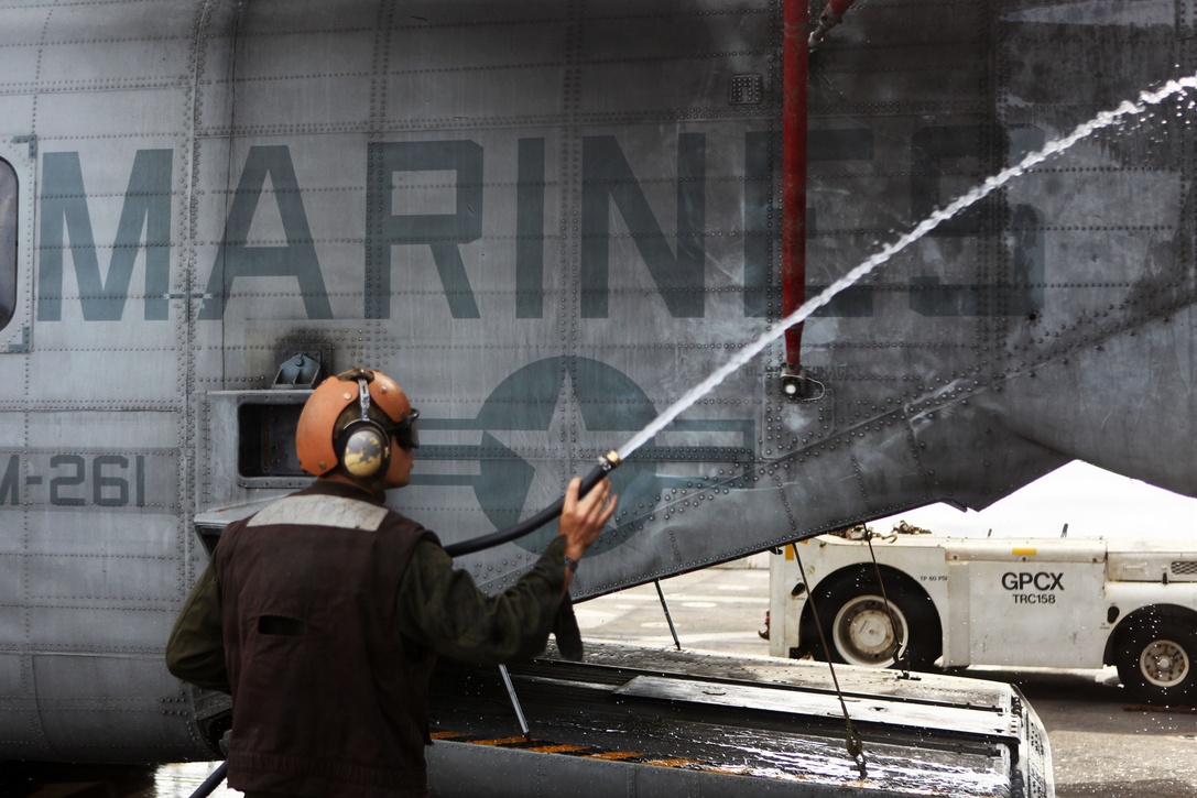A Marine with Marine Medium Tiltrotor Squadron 261 (Reinforced), 24th Marine Expeditionary Unit, washes a CH-53E Super Stallion during daily maintenance aboard the USS New York, Dec. 8, 2012. The 24th Marine Expeditionary Unit is coming home from a nine-month deployment with the Iwo Jima Amphibious Ready Group in which they served as an expeditionary crisis response force in the 5th and 6th Fleet areas of responsibility. (Official USMC Photo by: Cpl. Michael J. Petersheim/Released)