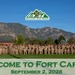 A large group photo of military personnel in camouflage uniforms assembled on a green athletic field at Fort Carson, Colorado. The image is formatted as a welcome graphic dated September 2, 2026, featuring the 'Mountain Post READY' logo. The Rocky Mountains are prominently visible in the background under a clear blue sky.