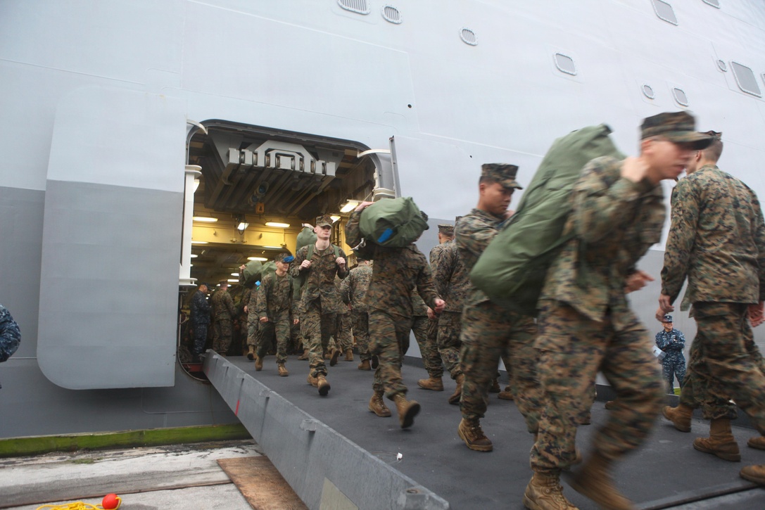 MOREHEAD CITY PORT FACILITY, N.C. - Marines with the 24th Marine Expeditionary Unit disembark the USS New York on their return home after a nine-month deployment, Dec. 16, 2012. Approximately 2,300 Marines and Sailors with the 24th MEU returned to the U.S. after being deployed as an expeditionary crisis response force with the Iwo Jima Amphibious Ready Group. They offloaded from the amphibious assault ships USS Iwo Jima, USS New York and USS Gunston Hall using amphibious vehicles, aircraft, and the Morehead City Port facility. (U.S. Marine Corps photo by Cpl. Michael Petersheim)