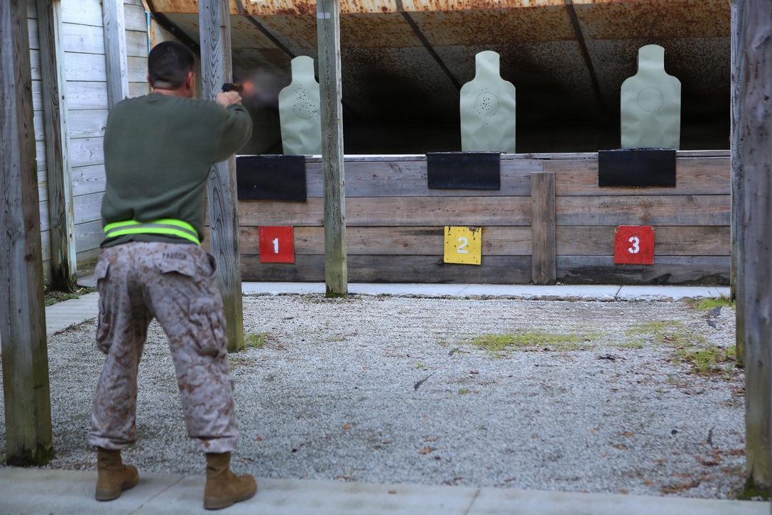 Maj. Ross Parrish, the operations officer for the 24th Marine Expeditionary Unit, fires on a target during a "run, shoot, run" physical training event, March 15, 2013, at Camp Lejeune. During the timed event, four-person groups completed an approximately six-mile run, conducted live-fired of the M9 pistol, and completed a combined total of 120 pull-ups. The 24th MEU returned from a nine-month deployment as an expeditionary crisis response force last December and is preparing for a change-of-command ceremony at the end of the week. (U.S. Marine Corps photo by Sgt. Monique Wallace)