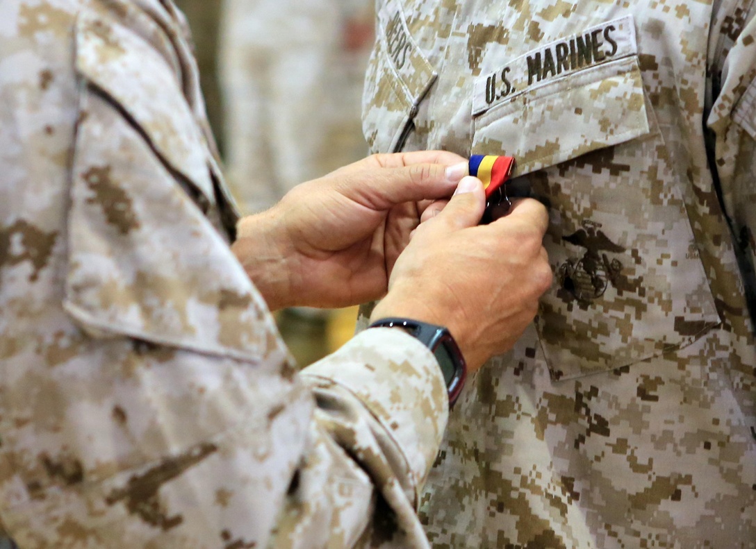 Col. Frank Donovan, the former commanding officer of the 24th Marine Expeditionary Unit, pins a Navy and Marine Corps Medal on a Marine during an awards ceremony June 3, 2013, at Camp Lejeune, N.C. The medals were awarded to the Marines for heroic actions while deployed with the 24th MEU in 2012. The Navy and Marine Corps Medal is the highest non-combatant medal awarded by the Department of the Navy to member of the U.S. Navy and Marine Corps.

