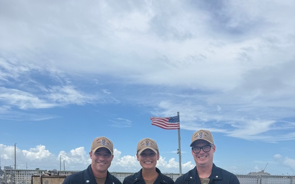 LTJG Anna Freyman stands proudly with USS CLEVELAND’s Commanding Officer and Executive Officer after her designation as a Surface Warfare Officer.