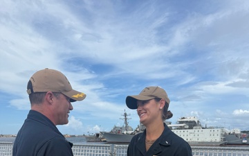 CDR Bruce Hallett congratulates LTJG Anna Freyman on her designation as a Surface Warfare Officer