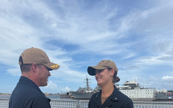CDR Bruce Hallett congratulates LTJG Anna Freyman on her designation as a Surface Warfare Officer
