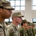 The image shows a formation of military personnel standing at attention inside a large building with tall windows. Two U.S. Army soldiers in OCP (Operational Camouflage Pattern) uniforms are prominently visible in the foreground, with name tapes reading 'RODRIGUE[Z]' and 'PHILIPPS'. Behind them, a row of soldiers wearing a different camouflage pattern — consistent with Japanese Ground Self-Defense Force uniforms — suggests this is a joint military exercise or ceremony.
