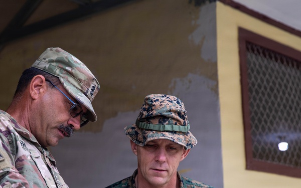 U.S. Army 1st Sgt. Thomas Ehlinger shows U.S Marine Corps. Col George Flynn a video