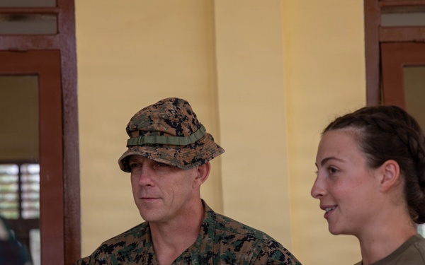 U.S. Marine Corps Col. George Flynn and 1st LT. Sabrina Basel listen to an engineer