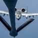 An A-10 Thunderbolt II (Warthog) attack aircraft is approaching a tanker aircraft for aerial refueling, photographed from the boom operator's position on the tanker. The receiving aircraft bears a shark mouth nose art and the serial number 80695. The tanker's refueling boom is visible in the foreground, marked with 'TENN ANG' indicating Tennessee Air National Guard.