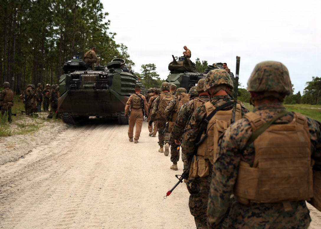 Marines with Kilo Company, Battalion Landing Team 3rd Battalion, 6th Marine Regiment, 24th Marine Expeditionary Unit, prepare to load onto amphibious assault vehicles to conduct a mechanized amphibious raid on Combat Town at Camp Lejeune, N.C., June 9, 2014. The training was part of Kilo Company’s mechanized raid package in preparation for the unit’s deployment with the 24th MEU at the end of the year. (U.S. Marine Corps photo by Lance Cpl. Joey Mendez)