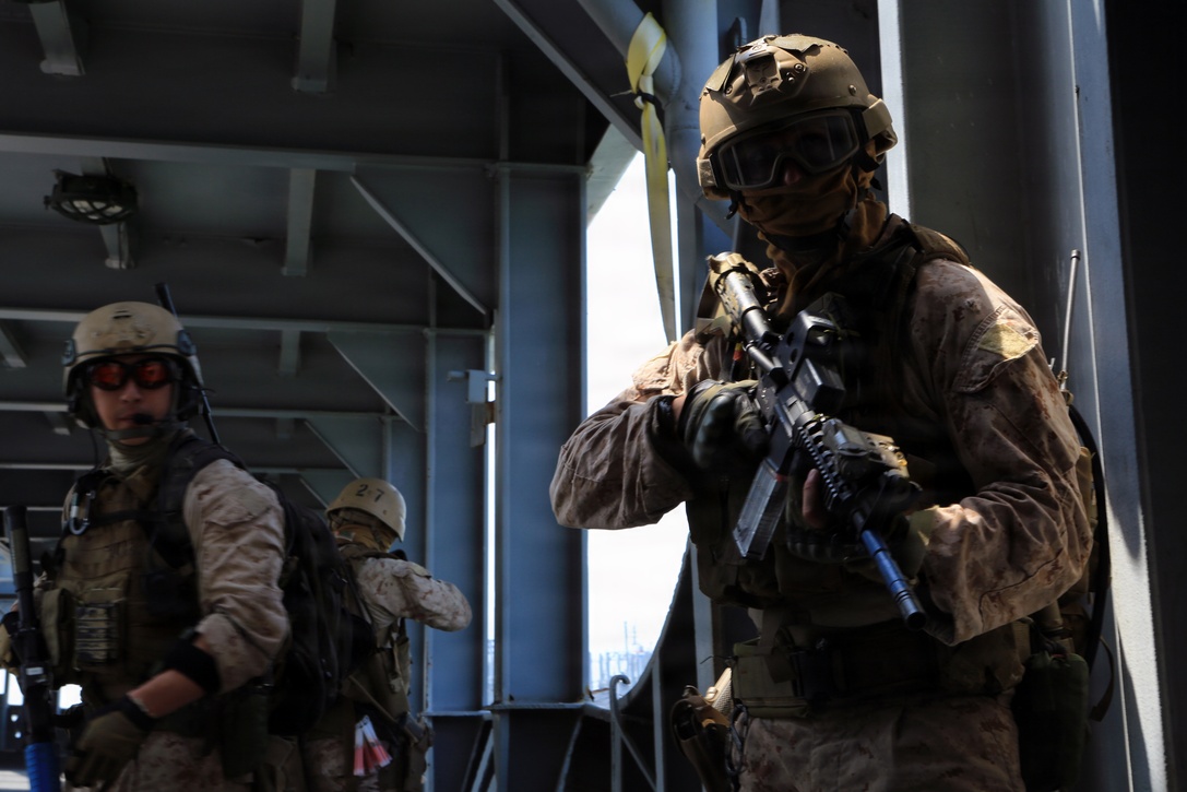 A Maritime Raid Force Marine, 24th Marine Expeditionary Unit, provides security during a Visit, Board, Search, and Seizure exercise during Realistic Urban Training at Joint Base Langley-Eustis, Va., July 13, 2014. VBSS operations are primarily conducted by the Maritime Raid Force, a unit sourced from 2d Reconnaissance Battalion, for the purpose of Maritime Interdiction Operations.  RUT is the first major pre-deployment training exercise for the 24th MEU in preparation for their deployment later this year.  (U.S. Marine Corps photo by Cpl. Devin Nichols)