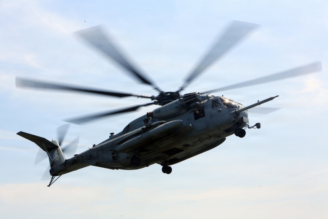 A CH-53E Super Stallion from the 24th Marine Expeditionary Unit’s Aviation Combat Element, Marine Medium Tiltrotor  Squadron 365 (Reinforced), approaches a ship during a Visit, Board, Search, and Seizure exercise as a part of Realistic Urban Training at Joint Base Langley-Eustis, Va., July 13, 2014. VBSS operations are primarily conducted by the unit’s Maritime Raid Force, a unit sourced from 2d Reconnaissance Battalion, for the purpose of Maritime Interdiction Operations.  RUT is the first major pre-deployment training exercise for the 24th MEU in preparation for their deployment later this year.  (U.S. Marine Corps photo by Cpl. Devin Nichols)
