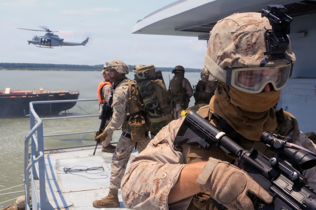 A Maritime Raid Force Marine, 24th Marine Expeditionary Unit, provides security during a Visit, Board, Search, and Seizure exercise as a part of Realistic Urban Training at Joint Base Langley-Eustis, Va., July 13, 2014. VBSS operations are primarily conducted by the Maritime Raid Force, a unit sourced from 2d Reconnaissance Battalion, for the purpose of Maritime Interdiction Operations.  RUT is the first major pre-deployment training exercise for the 24th MEU in preparation for their deployment later this year.  (U.S. Marine Corps photo by Cpl. Devin Nichols)