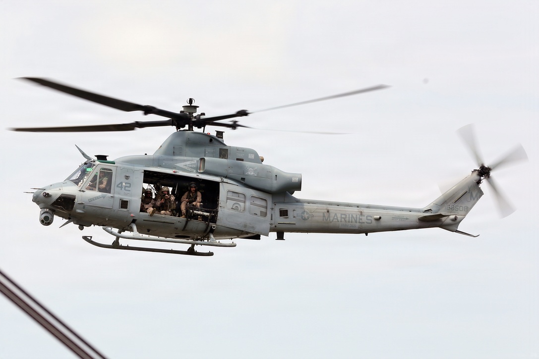 A UH-1Y Huey from the 24th Marine Expeditionary Unit’s Aviation Combat Element, Marine Medium Tiltrotor  Squadron 365 (Reinforced), hovers around a ship while members of the MEU’s Maritime Raid Force provide sniper coverage during a Visit, Board, Search, and Seizure exercise as a part of Realistic Urban Training at Joint Base Langley-Eustis, Va., July 13, 2014. VBSS operations are primarily conducted by the Maritime Raid Force, a unit sourced from 2d Reconnaissance Battalion, for the purpose of Maritime Interdiction Operations.  RUT is the first major pre-deployment training exercise for the 24th MEU in preparation for their deployment later this year.  (U.S. Marine Corps photo by Lance Cpl. Dani A. Zunun)