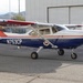 A Civil Air Patrol Cessna aircraft with tail number N753CP is parked on a tarmac in front of a hangar. The aircraft is painted in the distinctive Civil Air Patrol livery of blue, white, and red with the organization's shield emblem visible on the fuselage. The propeller appears to be spinning, suggesting the engine is running.