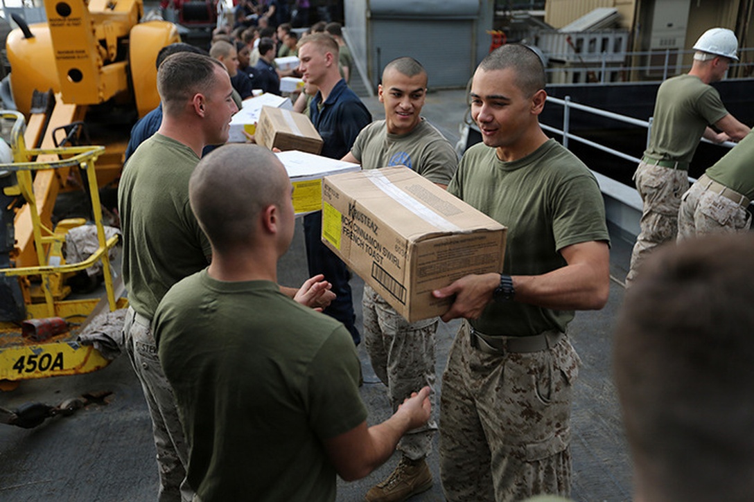 Marines with the 24th Marine Expeditionary Unit, and Sailors with the Iwo Jima Amphibious Ready Group, move supplies during a “resupply at sea,” or RAS, aboard the amphibious dock landing ship USS Fort McHenry, March 31, 2015. The 24th MEU is embarked on the ships of the Iwo Jima Amphibious Ready Group and deployed to maintain regional security in the U.S. 5th Fleet area of operations.  (U.S. Marine Corps photo by Sgt. Devin Nichols)
