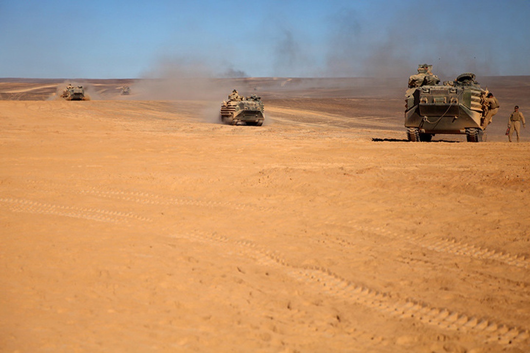 Amphibious Assault Vehicles assigned to Kilo Company, Battalion Landing Team 3rd Battalion, 6th Marine Regiment, 24th Marine Expeditionary Unit, line up to refuel their vehicles, in preparation for Exercise Eager Lion 2015 in Jordan, May 3, 2015. Eager Lion is a recurring multinational exercise designed to strengthen military-to-military relationships, increase interoperability between partner nations, and enhance regional security and stability. The 24th MEU is embarked on the ships of the Iwo Jima Amphibious Ready Group and deployed to maintain regional security in the U.S. 5th Fleet area of operations. (U.S. Marine Corps photo by Lance Cpl. Austin A. Lewis/Released)