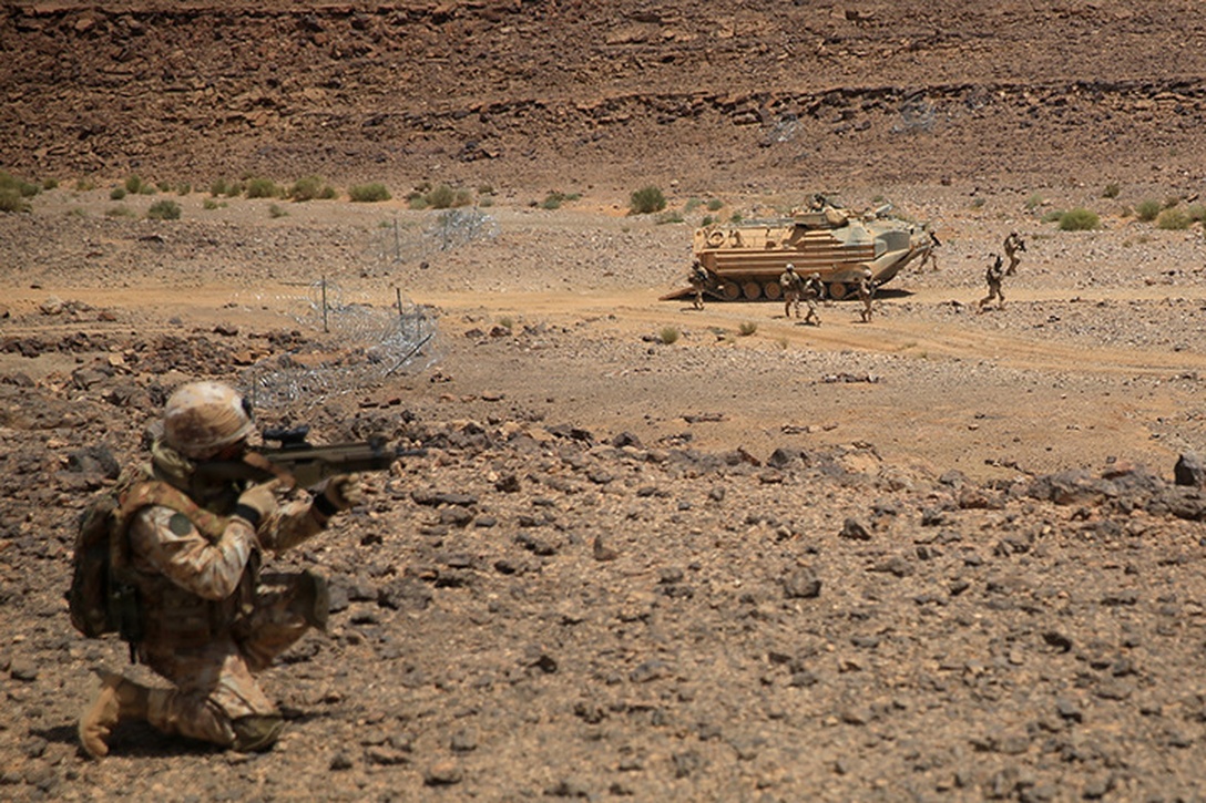 1505011-M-WA276-123: JORDAN (May 11, 2015) An Italian Marine provides security as members of his platoon exit an Assault Amphibious Vehicle with Kilo Company, Battalion Landing Team 3rd Battalion, 6th Marine Regiment, 24th Marine Expeditionary Unit, during platoon attack drills, as part of Exercise Eager Lion 2015, in Jordan, May 11, 2015. Eager Lion is a recurring multinational exercise designed to strengthen military-to-military relationships, between partner nations and enhance regional security and stability. The 24th MEU is embarked on the ships of the Iwo Jima Amphibious Ready Group and deployed to maintain regional security in the U.S. Fifth Fleet area of operations. (U.S. Marine Corps photo by Lance Cpl. Dani A. Zunun)
