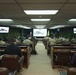 Chilean Army military personnel attend briefing in conference room with Chilean and unit flags displayed