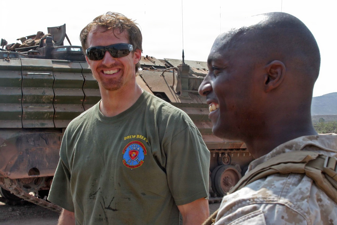NFL players Drew Brees from the New Orleans Saints, Billy Miller from the New Orleans Saints, and Donnie Edwards from the Kansas City Chiefs visit Marines from 24th Marine Expeditionary Unit in Djibouti, Africa as part of a USO tour March 29, 2010.  Marines had a chance to get autographs, and show the players some of the training the Marines have been participating in while in Djibouti.  Players also had a chance to get some hands on training from some of the Marines.  Marines and Sailors of the 24th MEU are conducting a series of sustainment and joint training exercises in Djibouti while deployed with the Nassau Amphibious Ready Group as the theater reserve for Central Command.   (U.S. Marine Corps photo by Gunnery Sgt James Frank)