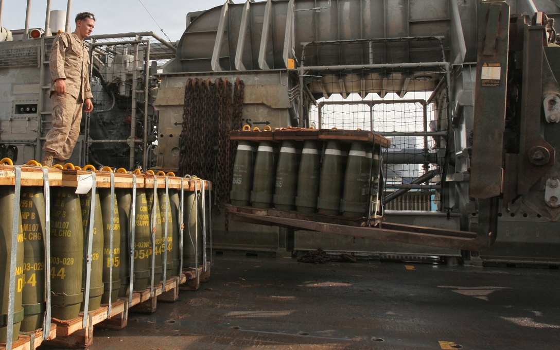 Cpl. Will D. Hoover, ammunition technician with Headquarters platoon, Combat Logistics Battalion 24, 24th Marine Expeditionary Unit, supervises a Tractor Rubber-tired Articulated Steering, Multipurpose (TRAM) forklift removing a pallet of howitzer artillery rounds to a staging area April 17, 2010.  Hoover was responsible an ammunition load transported from USS Ashland to shore. He is currently the only ammo technician serving as an ammunition liaison while it's stored for upcoming training events during the 24th MEU's deployment.  The 24th MEU is currently on a seven month deployment, and is the theatre reserve force for Central Command.  (U.S. Marine Corps photo by Sgt. Alex C. Sauceda)