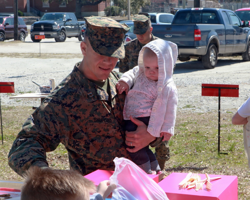 Marines and Sailors with the 24th Marine Expeditionary Unit's Command Element and their families enjoy a lunch together during a barbecue March 8, at the 24th MEU Headquarters Building.