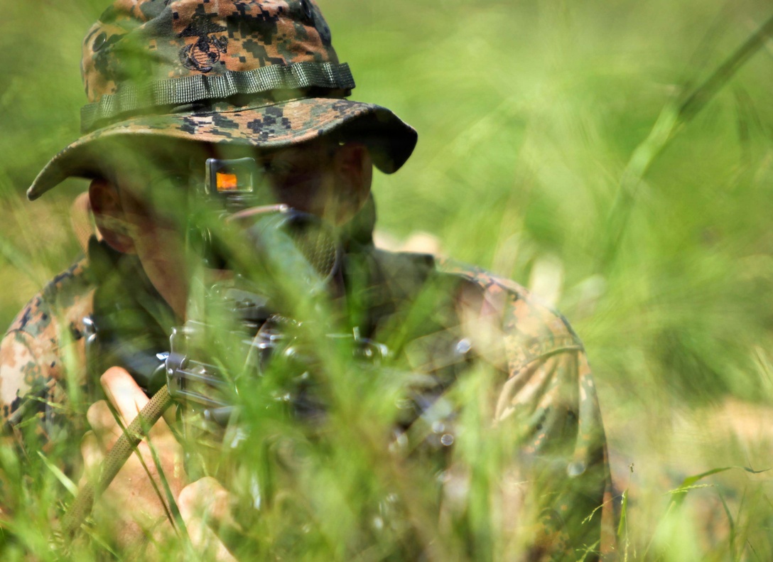 Lance Cpl. Stephen Williams, an automatic rifleman with 3rd Platoon, Charlie Company, 1st Battalion, 2nd Marine Regiment, looks down the scope of his M-249 Squad Automatic Rifle while conducting Military Operations in Urban Terrain training at the Urban Assault Course on Fort Pickett, Va., Sep. 12, 2011. More than 900 Marines and Sailors are taking part in the Deployment for Training exercise at Fort Pickett, Sept. 6-23. The battalion is scheduled to attach to the 24th Marine Expeditionary Unit as its Battalion Landing Team a few days after the training.