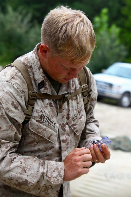 Seaman Derrick Reddick, a hospital corpsman with Combat Logistics Battalion 24, Combat Logistics Regiment 27, 2nd Marine Logistics Group, tests water from a Tactical Water Purification System, on Fort Pickett, Va., Sep. 18, 2011. More than 900 Marines and Sailors are taking part in the Deployment for Training exercise at Fort Pickett, Sept. 6-23. The battalion is scheduled to attach to the 24th Marine Expeditionary Unit as its Battalion Landing Team a few days after the training. (Official USMC Photo by: Lance Cpl. Michael Petersheim/Released)