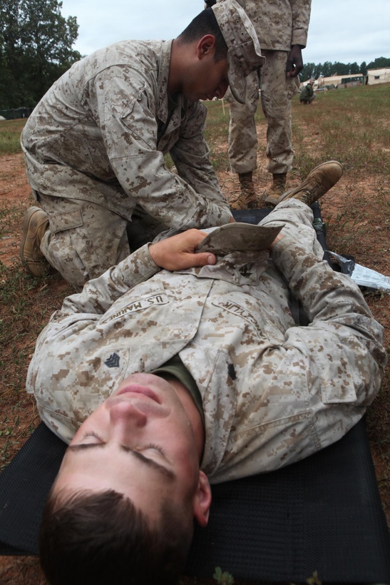 Petty Officer 2nd Class Alejanrdo Pedroza, a hospital corpsman with Combat Logistics Battalion 24, Combat Logistics Regiment 27, 2nd Marine Logistics Group, applies a tourniquet during a simulated mass casualties exercise on Fort Pickett, Va., Sept. 18, 2011. More than 900 Marines and sailors are taking part in the Deployment for Training exercise at Fort Pickett, Sept. 6-23. The battalion is scheduled to attach to the 24th Marine Expeditionary Unit as its battalion landing team a few days after the training.
