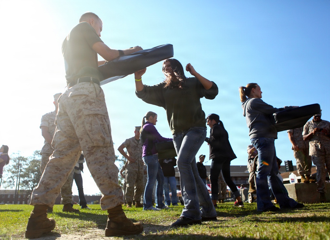 Spouses and families of Marines and Sailors with 1st Battalion, 2nd Marine Regiment, receive instructions on how to properly conduct Marine Corps Martial Arts Program movements during Jane Wayne Day on Camp Lejeune, N.C., Oct. 6, 2011. Spouses and families of the 24th Marine Expeditionary Unit's Battalion Landing Team came together to participate in various events such as MCMAP, Combat Fitness Test, and Rifle Marksmanship.