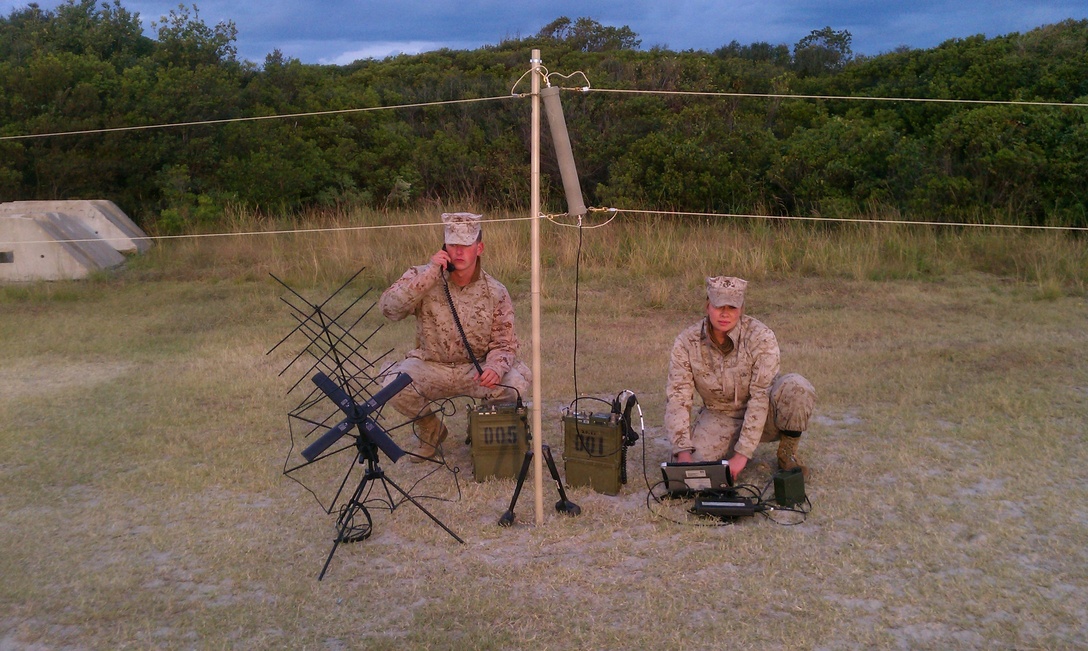 Cpl. Korey M. Lewis (left) and LCpl. Erica J. Ratz, field radio operators with the command element of the 24th Marine Expeditionary Unit, provide shore-to-ship communication support during the Amphibious Squadron 8 / 24th MEU Integration Training exercise (PMINT) Oct. 31, 2011.  The command element communications section provided Communication Support Teams (CST) on Onslow Beach, Camp Lejeune, N.C., to ensure Marines were able to communicate effectively from land-based operations to the amphibious assault ships USS Iwo Jima, USS New York and USS Gunston Hall during onload and offload operations throughout PMINT.