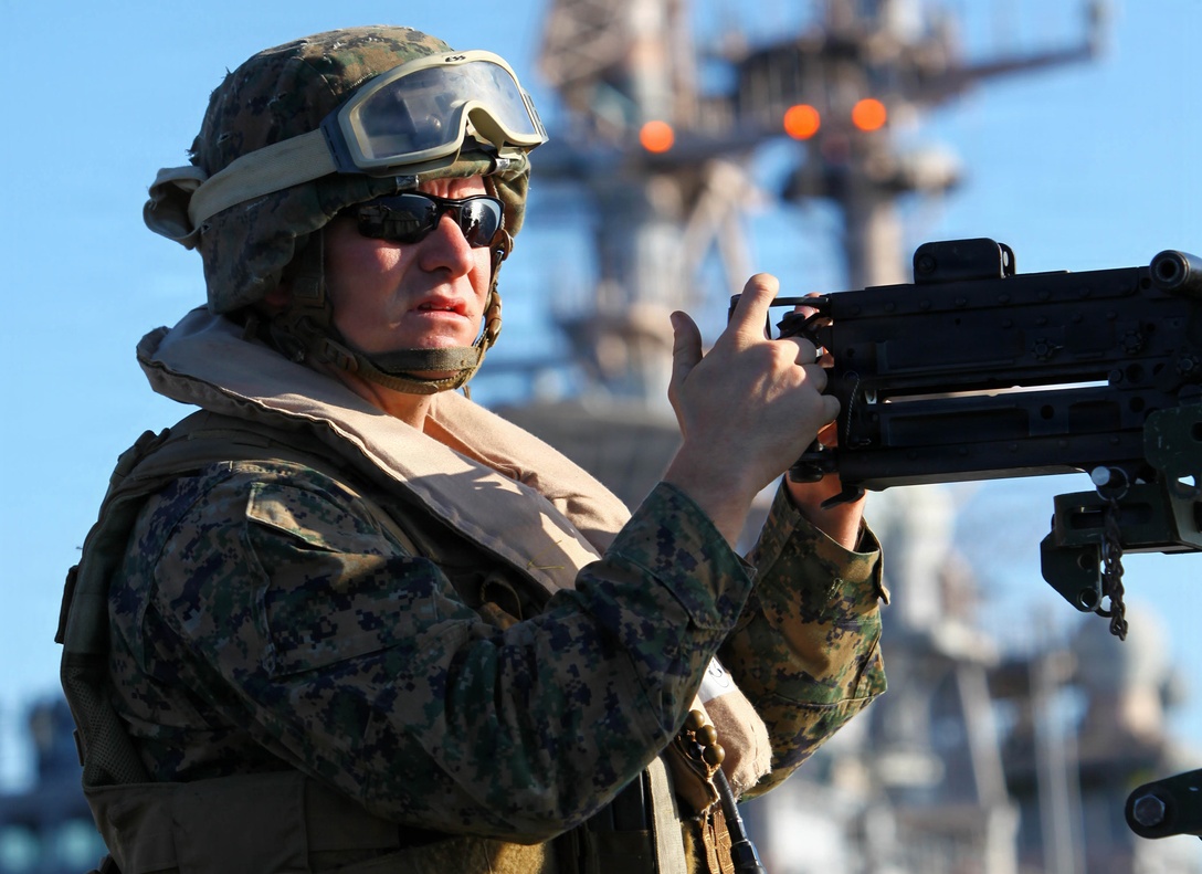 Lance Cpl. Ewen DeWitt, a machine gunner with Weapons Company, Battalion Landing Team 1st Battalion, 2nd Marine Regiment, 24th Marine Expeditionary Unit, mounts a M-2 .50-caliber machine gun on top of an Internally Transportable Vehicle during the Defense of the Amphibious Task Force Naval qualification exercise aboard the USS Iwo Jima (LHD 7) Dec. 3, 2011. DATF is one of many qualifications that make up Composite Training Unit Exercise (COMPTUEX), scheduled to take place Nov. 28 to Dec. 21. The DATF drill allowed the Marines to integrate with their Navy counterparts to rehearse how they would protect the ships of the amphibious ready group while traveling through high threat areas at sea.