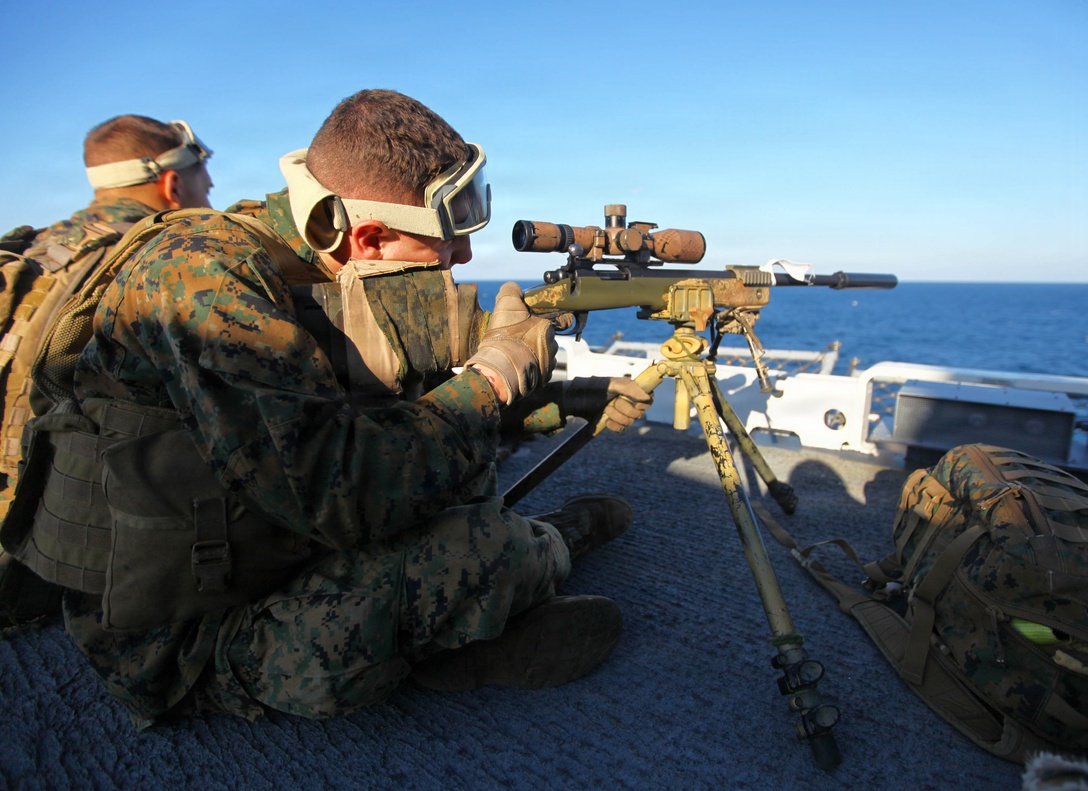 Corporal Jareth Falls, a scout sniper with Headquarters and Support Company, Battalion Landing Team, 1st Battalion, 2nd Marine Regiment, 24th Marine Expeditionary Unit, sights in his M-40 A5 sniper rifle during the Defense of the Amphibious Task Force Naval qualification exercise aboard the USS Iwo Jima (LHD 7) Dec. 3, 2011. DATF is one of many qualifications that make up Composite Training Unit Exercise (COMPTUEX), scheduled to take place Nov. 28 to Dec. 21. The DATF drill allowed the Marines to integrate with their Navy counterparts to rehearse how they would protect the ships of the amphibious ready group while traveling through high threat areas at sea.