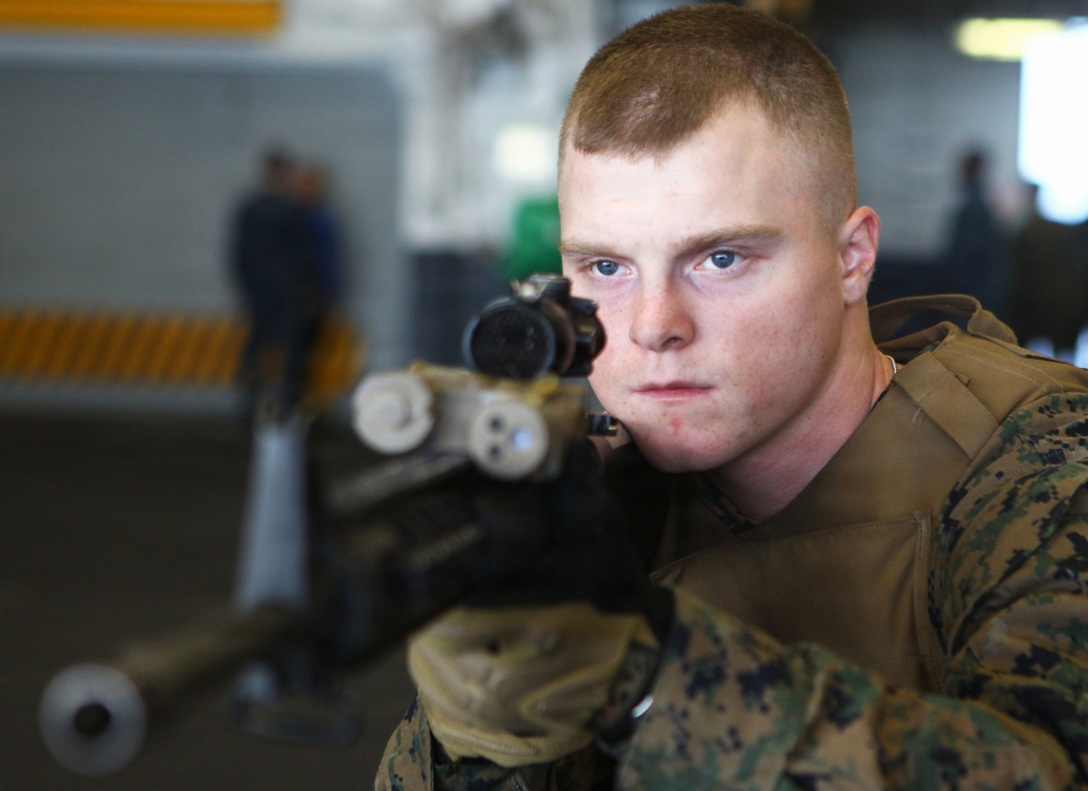Private First Class Robert Roessler, a rifleman with Bravo Company, Battalion Landing Team 1st Battalion, 2nd Marine Regiment, 24th Marine Expeditionary Unit, sights in on his M-16 A4 service rifle during training drills aboard the USS Iwo Jima (LHD 7) Dec. 6, 2011. The 24th MEU is currently taking part in Composite Training Unit Exercise (COMPTUEX), scheduled to take place Nov. 28 to Dec. 21. The training is meant to develop cohesion between the 24th MEU and Amphibious Squadron 8 (PHIBRON 8) in conducting amphibious operations, crisis response, and limited contingency operations while operating from the sea.