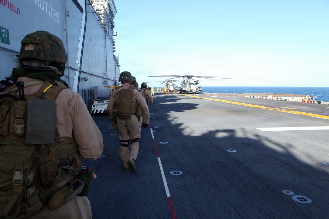Marines with the 24th Marine Expeditionary Unit’s Force Reconnaissance Platoon walk toward a CH-53 Super Stallion Helicopter waiting to transport them to the USNS Arctic to conduct a simulated Expanded, Visit, Board, Search and Seizure mission, Dec. 5. Marines with the 24th MEU’s Force Reconnaissance Platoon and Security Element, Headquarters and Service Company, Battalion Landing Team 1st Battalion, 2nd Marine Regiment, 24th MEU, conducted three simulated EVBSS mission as part of  the Composite Training Unit Exercise (COMPTUEX.) The EVBSS training is meant to prepare the Marines and Sailors to board vessels from sea and air. COMPTUEX, scheduled to take place Nov. 28 to Dec. 21, is the second of three at-sea exercises meant to build cohesion between the 24th MEU and Amphibious Squadron 8 (PHIBRON 8) in conducting amphibious operations, crisis response, and limited contingency operations while operating from the sea.