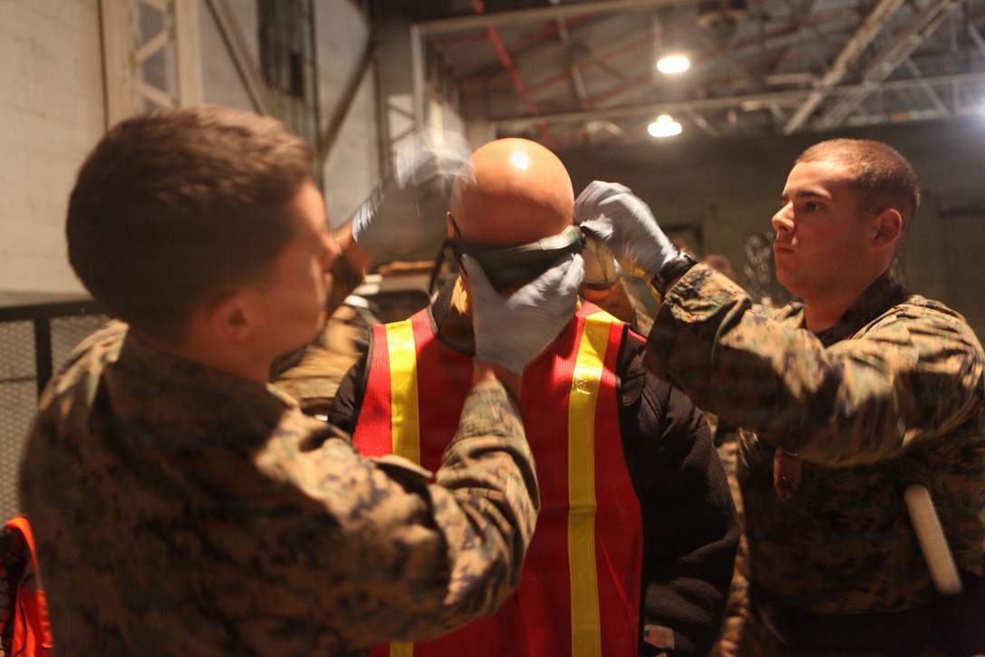 Marines with Military Police Detachment, Combat Logistics Battalion 24,  24th Marine Expeditionary Unit, prepare a simulated detainee for transportation here after he was captured during a mock raid conducted by the 24th MEU’s Force Reconnaissance Platoon and Security Element Platoon, Battalion Landing Team 1st Battalion, 2nd Marine Regiment, 24th MEU, at a Virginia Beach police training facility in Creeds Jan.17, 2012. The raid was part of the 24th MEU’s Realistic Urban Training (RUT) exercise scheduled Jan. 5-20, which focuses on conducting off-base missions near the towns of Farmville and Creeds to prepare for the various operations they may conduct while deployed.