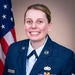 A formal military portrait of a U.S. Air Force enlisted member in dress blue uniform, smiling in front of an American flag. The subject wears the rank of Staff Sergeant (visible chevrons on sleeve) and displays multiple service ribbons and a Senior badge with star device. The name tape reads 'DENISON'.