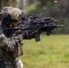 The image shows South Korean military personnel conducting a live-fire shooting exercise or demonstration. The foreground soldier is clearly identifiable by the South Korean flag patch on the left shoulder, firing what appears to be a Daewoo K2 or similar South Korean-issue assault rifle. Spent brass casings are visibly ejecting from the weapon, indicating active firing.