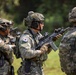 The image shows multiple soldiers in South Korean military uniforms conducting what appears to be a field training exercise or demonstration. The soldiers are equipped with full tactical gear including helmets, body armor, communication headsets, and assault rifles. South Korean national flag patches are clearly visible on their uniforms.